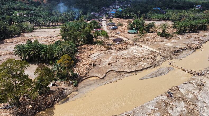 FILE - This aerial photo taken using drone shows a village affected by a flash flood in Batang Toru, North Sumatra, Indonesia, on Dec. 1, 2025. (AP Photo/Binsar Bakkara, File)