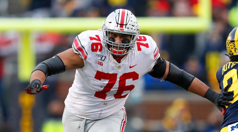 FILE - Ohio State offensive lineman Thayer Munford (75) blocks against Michigan in the second half of an NCAA college football game in Ann Arbor, Mich., in this Saturday, Nov. 30, 2019, file photo. Ohio State stars leaving early for the NFL happens every winter, but perhaps the more surprising news this time is about the number of important players who've decided to stay. Munford said he would be back. (AP Photo/Paul Sancya, File)