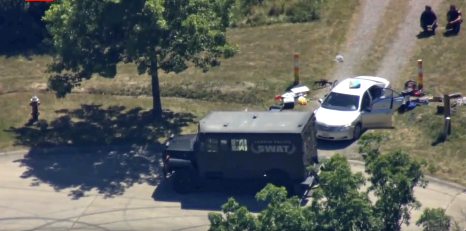 This aerial image taken from video provided by WEWS shows police working at the scene of shooting after police officers were wounded and a man was killed in an exchange of gunfire early Wednesday afternoon, July 23, 2025, in an industrial area of Lorain, Ohio. (WEWS via AP)