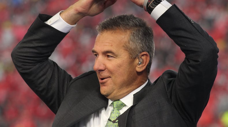 Former Ohio State coach Urban Meyer throws up an "O" during the Fox Sports pregame show before a game against Wisconsin on Saturday, Oct. 26, 2019, at Ohio Stadium in Columbus. David Jablonski/Staff
