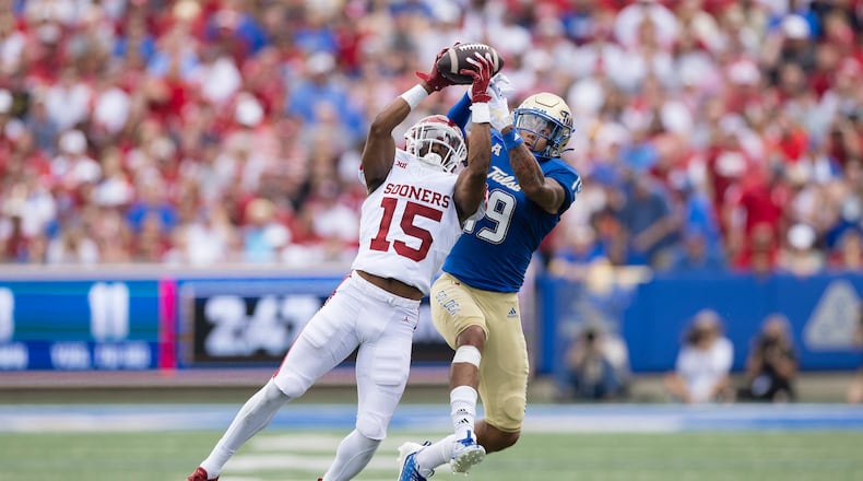 Oklahoma defensive back Kendel Dolby (15) intercepts a ball intended for Tulsa wide receiver Devan Williams (19) during the first half of an NCAA college football game Saturday, Sept. 16, 2023, in Tulsa, Okla. (AP Photo/Alonzo Adams)