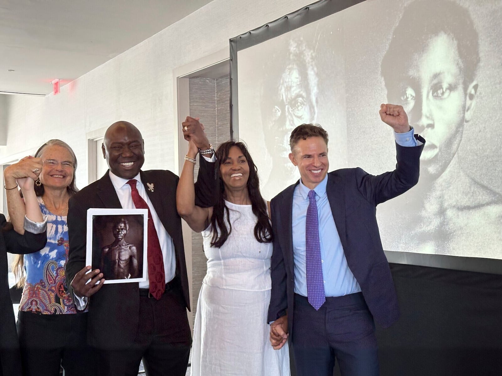 Susanna Moore, left, the great-great-great-granddaughter of Harvard biologist Louis Agassiz, celebrates with Tamara Lanier, second right, and attorneys Ben Crump and Josh Koskoff at the Boston Marriott Long Wharf hotel on Wednesday, March 28, 2025 in Boston, Mass. (AP Photo/Leah Willingham)
