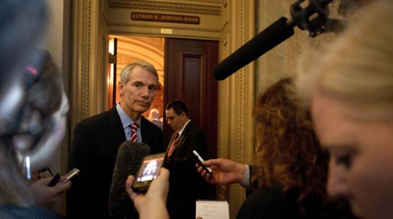 Sen. Rob Portman (R-Ohio) speaks to reporters as he departs a Senate Republican policy luncheon on Capitol Hill in Washington, April 9, 2013. Family members of Newtown shooting victims visited members of Congress Tuesday to press for gun legislation. (Doug Mills/The new York Times)