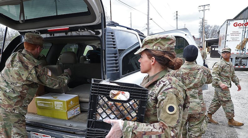 Ohio Gov. Mike DeWine on July 2, 2021, activated 185 additional Ohio National Guard members to support the Southwest border mission late this year at the request of the U.S. Department of Homeland Security and the National Guard Bureau. Pictured, Ohio National Guard members based in Springfield helped distributed food Jan. 13, 2021, at the Second Harvest Food Bank as a line of cars, waiting for food, wrapped around the food bank in Springfield. BILL LACKEY/STAFF