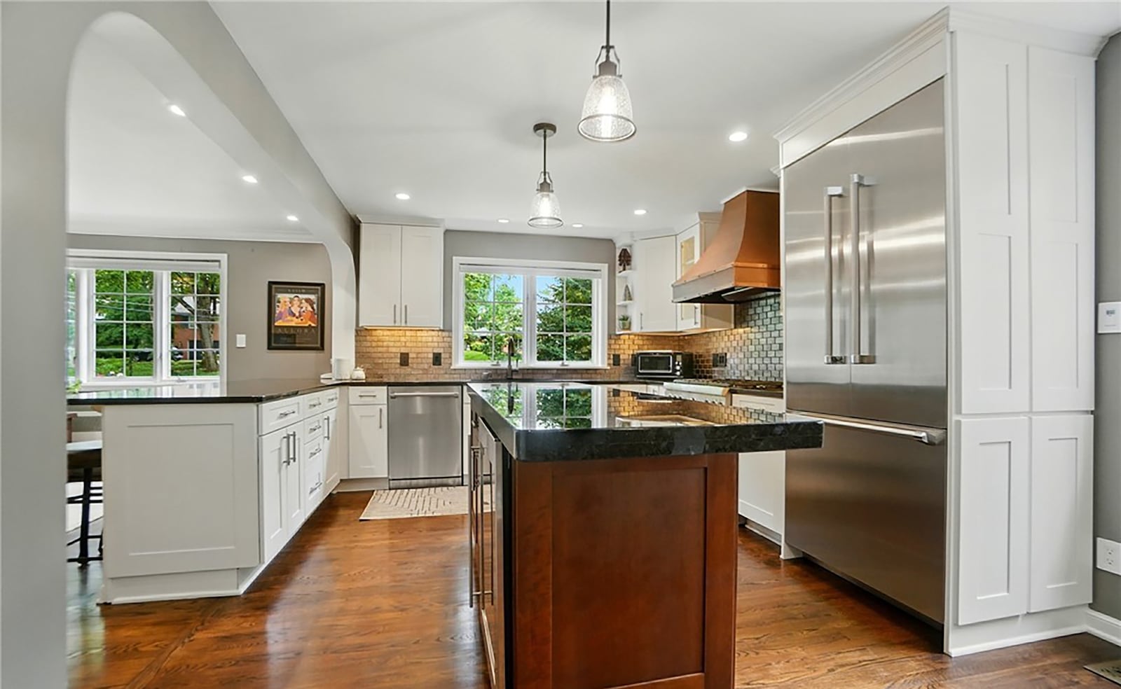 The kitchen has been recently remodeled with upscale appliances, tile backsplash and granite countertops. There is an island and a breakfast bar overlooking the morning room.