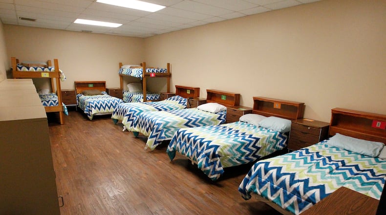 The women’s sleeping quarters at the Caring Kitchen in Urbana. BILL LACKEY/STAFF Judy Blair, right, and Nancy Denler, volunteers at the Caring Kitchen in Urbana, make up plates for lunch Thursday, June 29, 2017. BILL LACKEY/STAFF