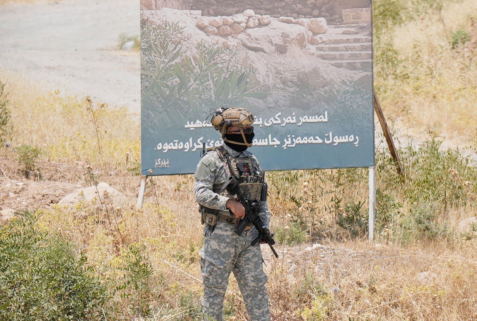 Forces of the regional Kurdish administration secure the area of the Jasana Cave ahead of a symbolic disarmament ceremony by the separatist PKK group as part of the peace process with Turkey, in Sulaymaniyah governorate, Iraq, Friday, July 11, 2025. (AP Photo/Hadi Mizban)
