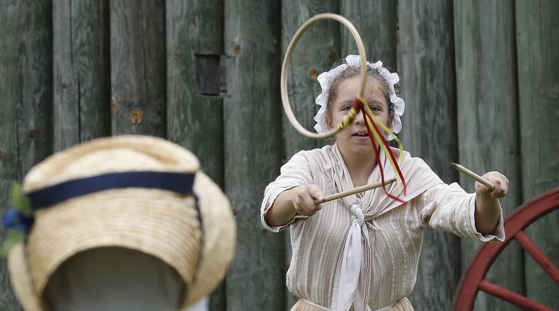 Claire LeMelle, 13, plays a game Saturday during last year’s Fair at New Boston. BILL LACKEY/STAFF