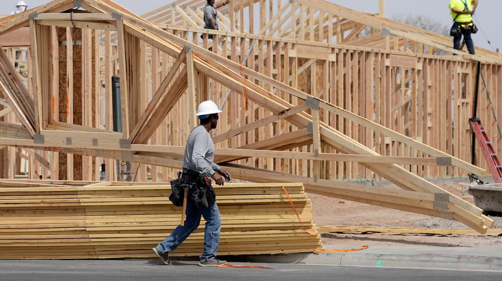 FILE - Construction workers install a lumber roof at a new home build Tuesday, April 1, 2025, in Laveen, Ariz. (AP Photo/Ross D. Franklin, File)