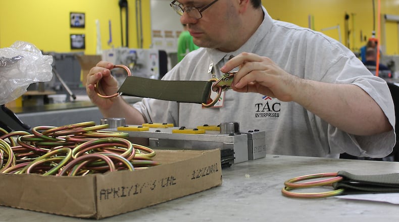 TAC Industries Inc employee Brian Golen puts parts together that will become cargo netting for the United States Air force. JEFF GUERINI/STAFF