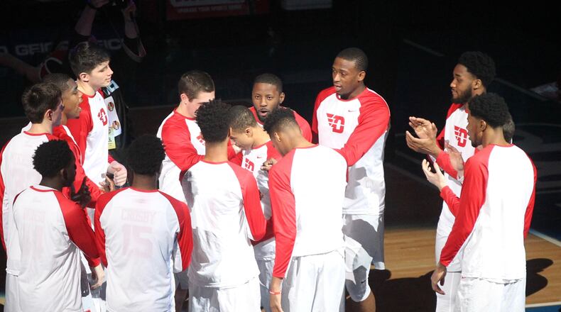 Dayton players huddle before a game against Davidson on Friday, March 10, 2017, at PPG Paints Arena in Pittsburgh. David Jablonski/Staff