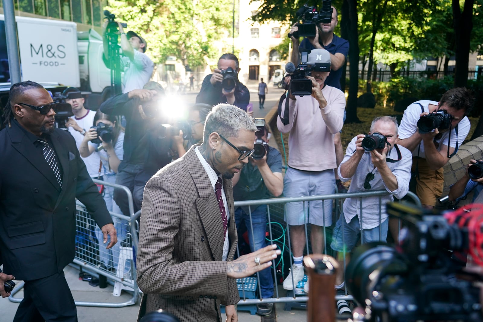 Grammy-winning singer Chris Brown makes his way into Southwark Crown Court, in London, Friday, July 11, 2025.(AP Photo/Alberto Pezzali)