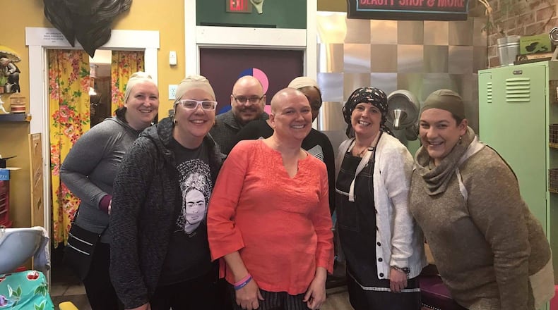 Friends wore bald head caps from Foy’s costume store during Kristen Wicker’s head-shaving shindig at Derailed Hair Salon in the Oregon District. Pictured left to right: Katie Wedell, Alexis Larsen, Anthony Shoemaker, Kristen Wicker, Amelia Robinson, Mindy Finch, Amy Forsthoefel. CONTRIBUTED