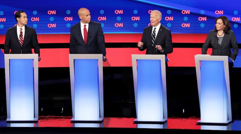 DETROIT, MICHIGAN - JULY 31: Democratic presidential candidate former Vice President Joe Biden (2nd R) speaks while Sen. Kamala Harris (D-CA) (R), Sen. Cory Booker (D-NJ) and former housing secretary Julian Castro listen during the Democratic Presidential Debate at the Fox Theatre July 31, 2019 in Detroit, Michigan. 20 Democratic presidential candidates were split into two groups of 10 to take part in the debate sponsored by CNN held over two nights at Detroits Fox Theatre. (Photo by Scott Olson/Getty Images)