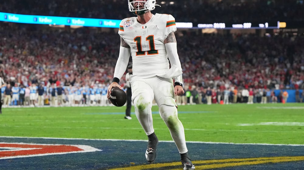 Miami quarterback Carson Beck scores a touchdown during the second half of the Fiesta Bowl NCAA college football playoff semifinal game against Mississippi, Thursday, Jan. 8, 2026, in Glendale, Ariz. (AP Photo/Rick Scuteri)