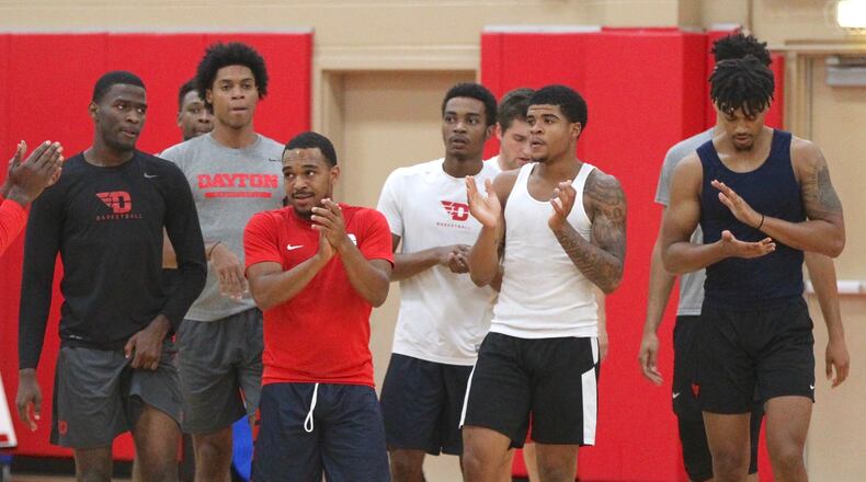 Dayton players huddle around coach Anthony Grant during practice on Wednesday, Sept. 26, 2018, at the Cronin Center. David Jablonski/Staff