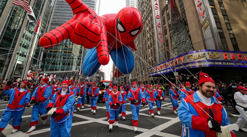 Balloon handlers guide the Spider Man balloon past Radio City Music Hall during the Macy's Thanksgiving Day Parade, Thursday, Nov. 27, 2025, in New York. (AP Photo/Eduardo Munoz Alvarez)
