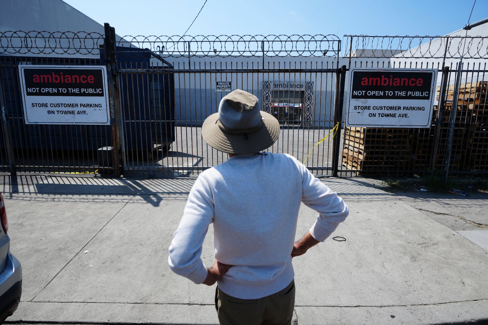 A man stands outside a business where federal immigration authorities conducted an operation on Friday, June 6, 2025, in Los Angeles. (AP Photo/Damian Dovarganes)