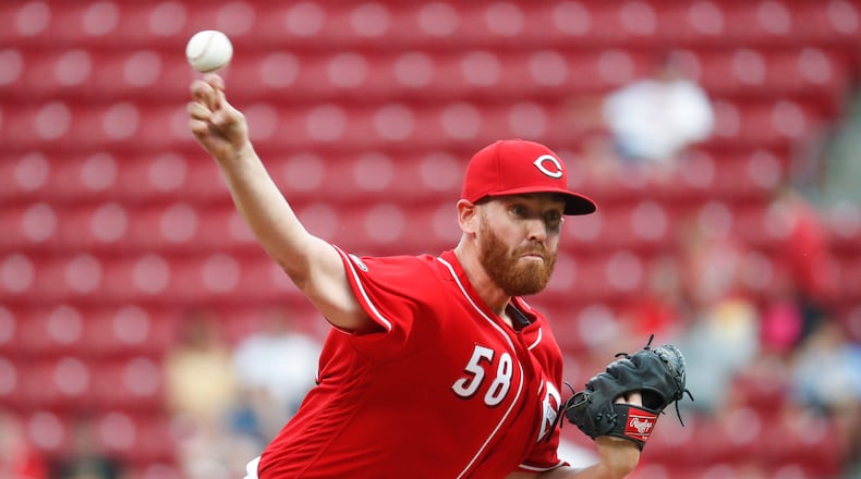 Cincinnati Reds starting pitcher Dan Straily throws during the first inning of a baseball game against the Texas Rangers, Tuesday, Aug. 23, 2016, in Cincinnati. (AP Photo/John Minchillo)
