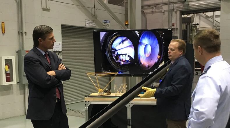 Dr. Andrew Williams, center, Air Force Research Laboratory Deputy Technology Executive Officer for Space Science & Technology, explains the engineering of the Roll-Out-Solar Array, or ROSA, to U.S. Senator Martin Heinrich during a past visit to AFRL’s Space Vehicles Directorate at Kirtland Air Force Base, New Mexico. (Courtesy photo)