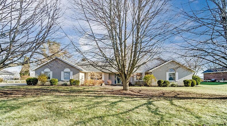 The 3-bedroom ranch includes about 2,890 sq. ft. of living space. The front is heavily landscaped and has mature trees. There is an attached, 3-car garage and concrete walkway. CONTRIBUTED PHOTO