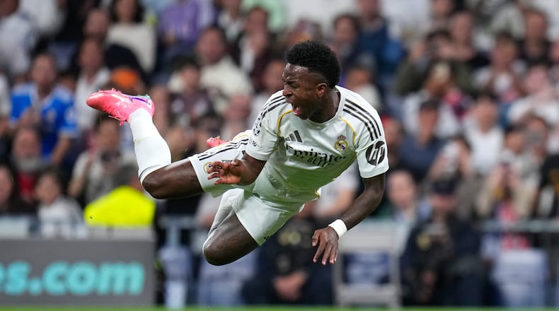 Real Madrid's Vinicius Junior falls during the second leg of the Champions League playoff soccer match between Real Madrid and Benfica in Madrid, Spain, Wednesday, Feb. 25, 2026. (AP Photo/Manu Fernandez)