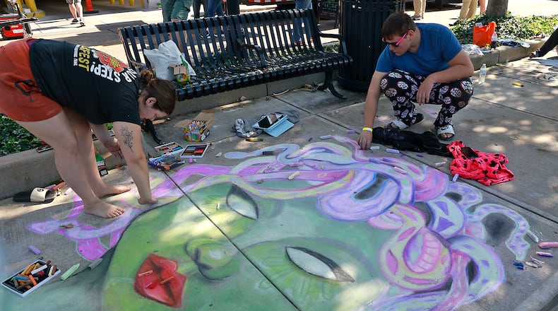 Journey Armstrong and Charlie Scott work on their chalk art Saturday, Oct. 5, 2024 during ChalkFest at National Road Commons Park in downtown Springfield. Dozens of amateur and professional artists from around the area showed off their skill on the sidewalks and streets around the park. ChalkFest also featured live music, food trucks and creative activities for the kids. BILL LACKEY/STAFF