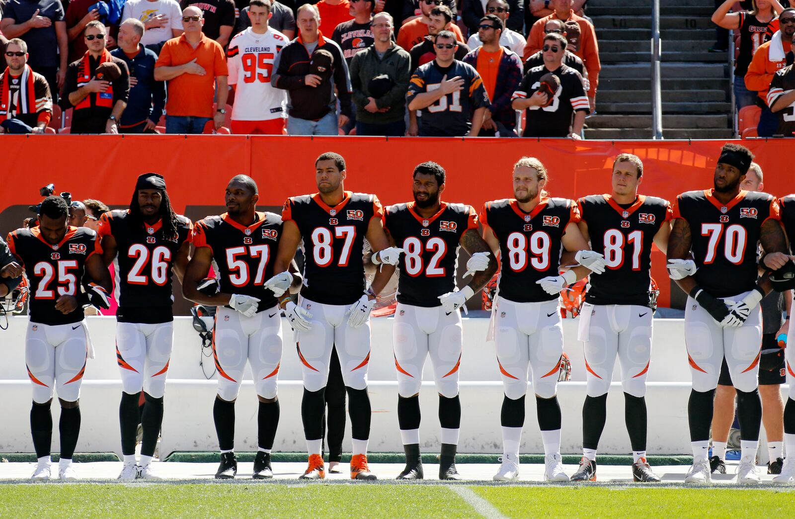 Cincinnati Bengals players lock arms during the national anthem before an NFL football game against the Cleveland Browns, Sunday, Oct. 1, 2017, in Cleveland. (AP Photo/Ron Schwane)
