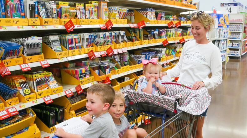 Brittany Rademacher, along with her kids, Ali, Mason and Camden, shop for back to school supplies at the Walmart in West Chester, Wednesday, July 26, 2017. GREG LYNCH / STAFF