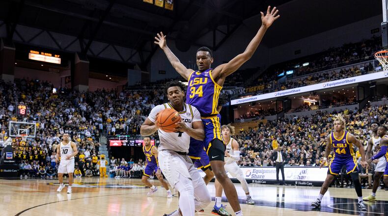 Missouri's DeAndre Gholston, turns away from LSU's Shawn Phillips, right, during the second half of an NCAA college basketball game Wednesday, Feb. 1, 2023, in Columbia, Mo. Missouri won 87-77.(AP Photo/L.G. Patterson)