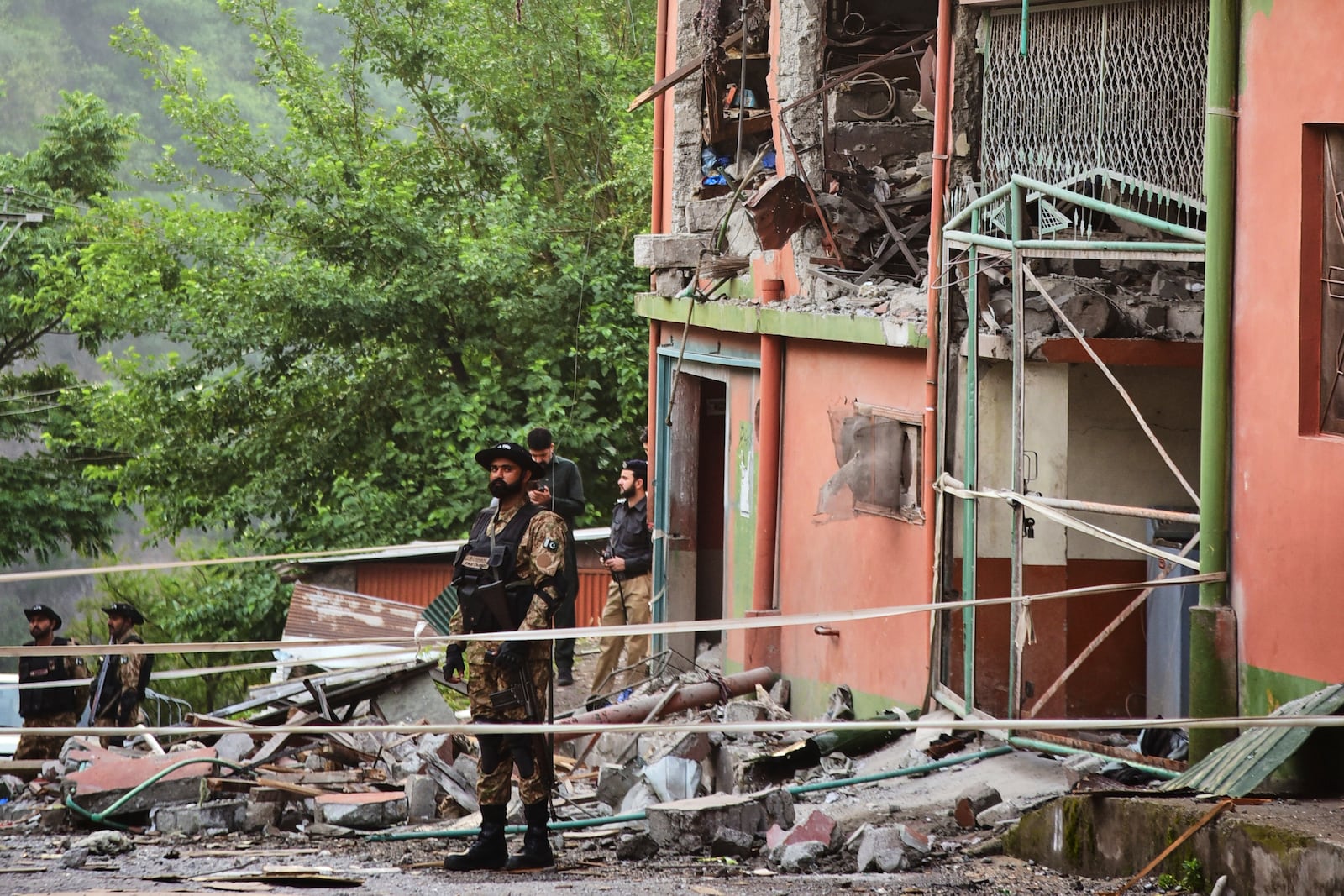 Army soldiers stand guard at a mosque building damaged by a suspected Indian missile attack near Muzaffarabad, the capital of Pakistan controlled Kashmir, on Wednesday, May 7, 2025. (AP Photo/M.D. Mughal)