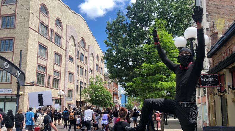 Protesters march through the Oregon District on May 31. CORNELIUS FROLIK / STAFF