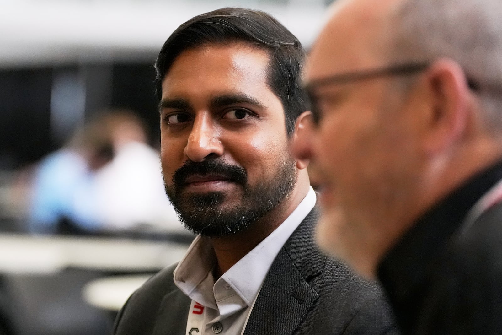 Pras Velagapudi, left, chief technology officer at Oregon-based Agility Robotics, listens during an interview at the Robotics Summit & Expo, Wednesday, April 30, 2025, in Boston. (AP Photo/Charles Krupa)