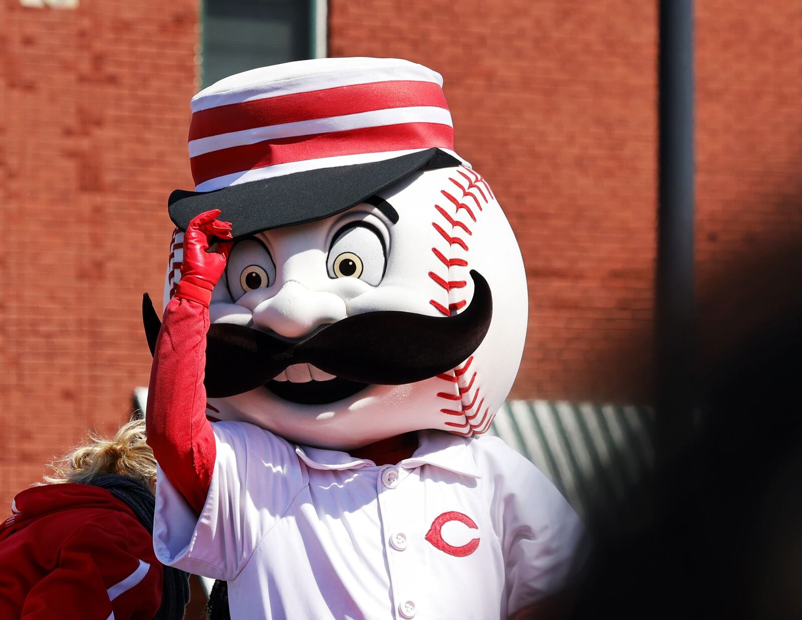 Mr. Redlegs tips his hat to the crowd as they cheer on the Cincinnati Reds during the Findlay Market Opening Day Parade Thursday, March 30, 2023 in Cincinnati. NICK GRAHAM/STAFF