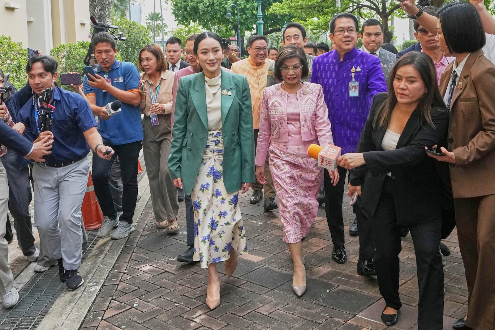 Thailand's Prime Minister Paetongtarn Shinawatra, center, arrives at Government House for a cabinet meeting in Bangkok, Thailand, Tuesday, July 1, 2025. (AP Photo/Sakchai Lalit)