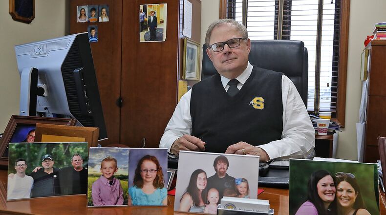 Gregg Morris is surrounded by pictures of his children and grandchildren in his office Wednesday. Morris is retiring as Shawnee Schools superintendent after seven years at the end of this school year. Bill Lackey/Staff