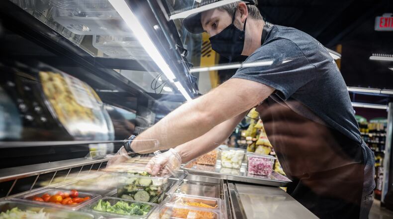 A Dayton doctor said communities should promote more groceries like the Gem City Market, which is a full-service grocery store and deli located in the Salem Avenue corridor, to help bring groceries to food deserts. In this file photo, Gem City Market Deli Manager, Chris Bender, puts together lunch salad bar at the market. JIM NOELKER/STAFF