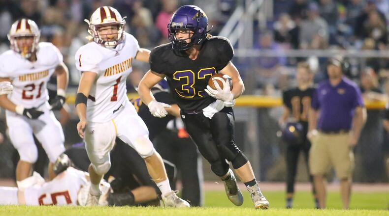 Mechanicsburg High School's Jake Hurst runs past Northeastern's Cade Houseman during a game at Mechanicsburg on Oct. 1, 2021. CONTRIBUTED PHOTO BY MICHAEL COOPER