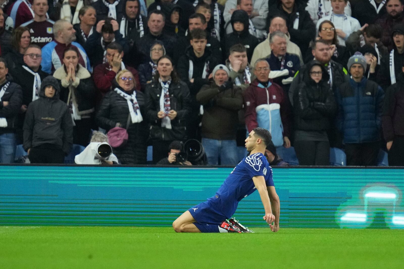 PSG's Achraf Hakimi celebrates after scoring his side's opening goal during the Champions League quarterfinal second leg soccer match between Aston Villa and Paris Saint-Germain at Villa Park stadium, Birmingham, England, Tuesday, April 15, 2025. (AP Photo/Kirsty Wigglesworth)