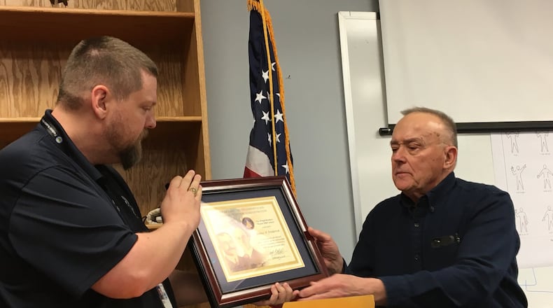 Jim Frederick of Springfield, right, receives the prestigious Wright Brothers Master Pilot Award from the Federal Aviation Association’s Jason Forshey during a special meeting of the Champaign County Pilots Association on Wednesday. Contributed Photo by Brett Turner