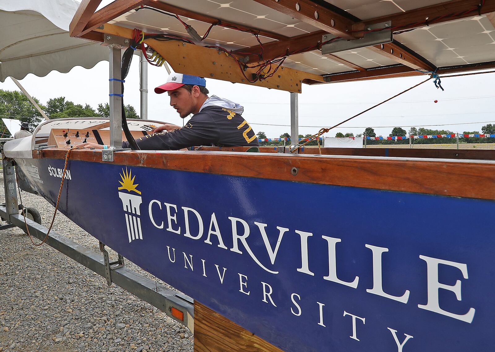 Ethan Beachy, a member of the Cedarville Solar Splash team works on their team's boat Frdiay, June 10, 2022. Teams of engineering students from all over the country competed in the annual Solar Splash event at the Clark County Fairgrounds lake from June 7-11 to see who could make the fastest and most efficient solar powered boat. BILL LACKEY/STAFF