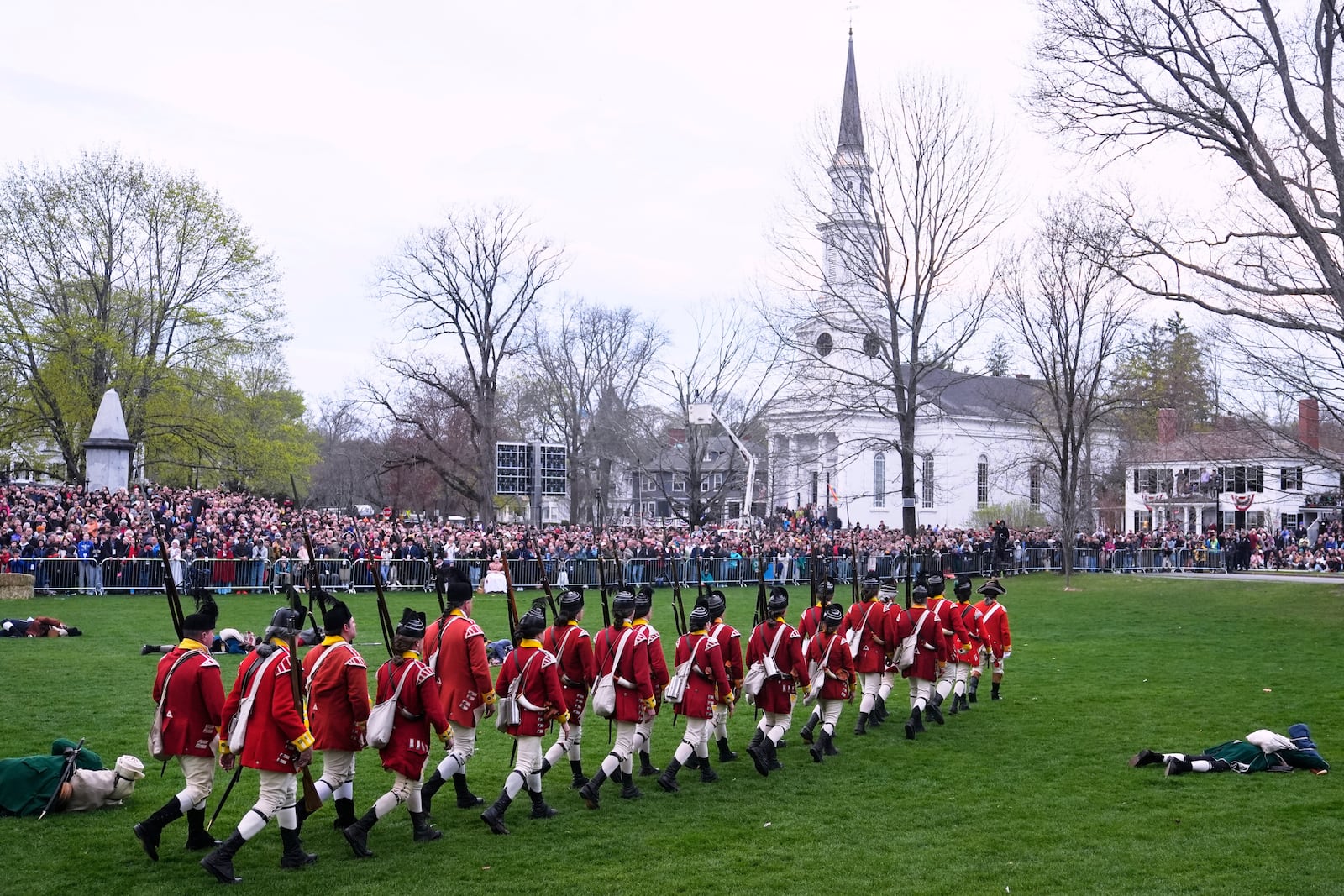 British Regulars march past fallen New England colonial militia, also known as a Minuteman, during a reenactment celebration of the 250th anniversary of the Battle of Lexington and start of the American Revolution, Saturday, April 19, 2025, in Lexington, Mass. (AP Photo/Charles Krupa)