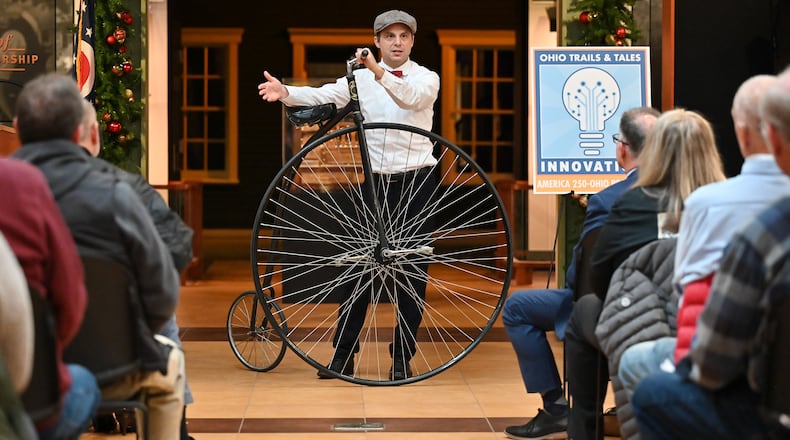 Leo DeLuca, community relations director at Dayton History, talks about the Wright Brothers and penny-farthing bicycles during an event launching the Ohio Innovation Trail, one of six experiential trails for America 250-Ohio's Trails and Tales program, on Tuesday, Nov. 18 at Carillon Historical Park. BRYANT BILLING/STAFF