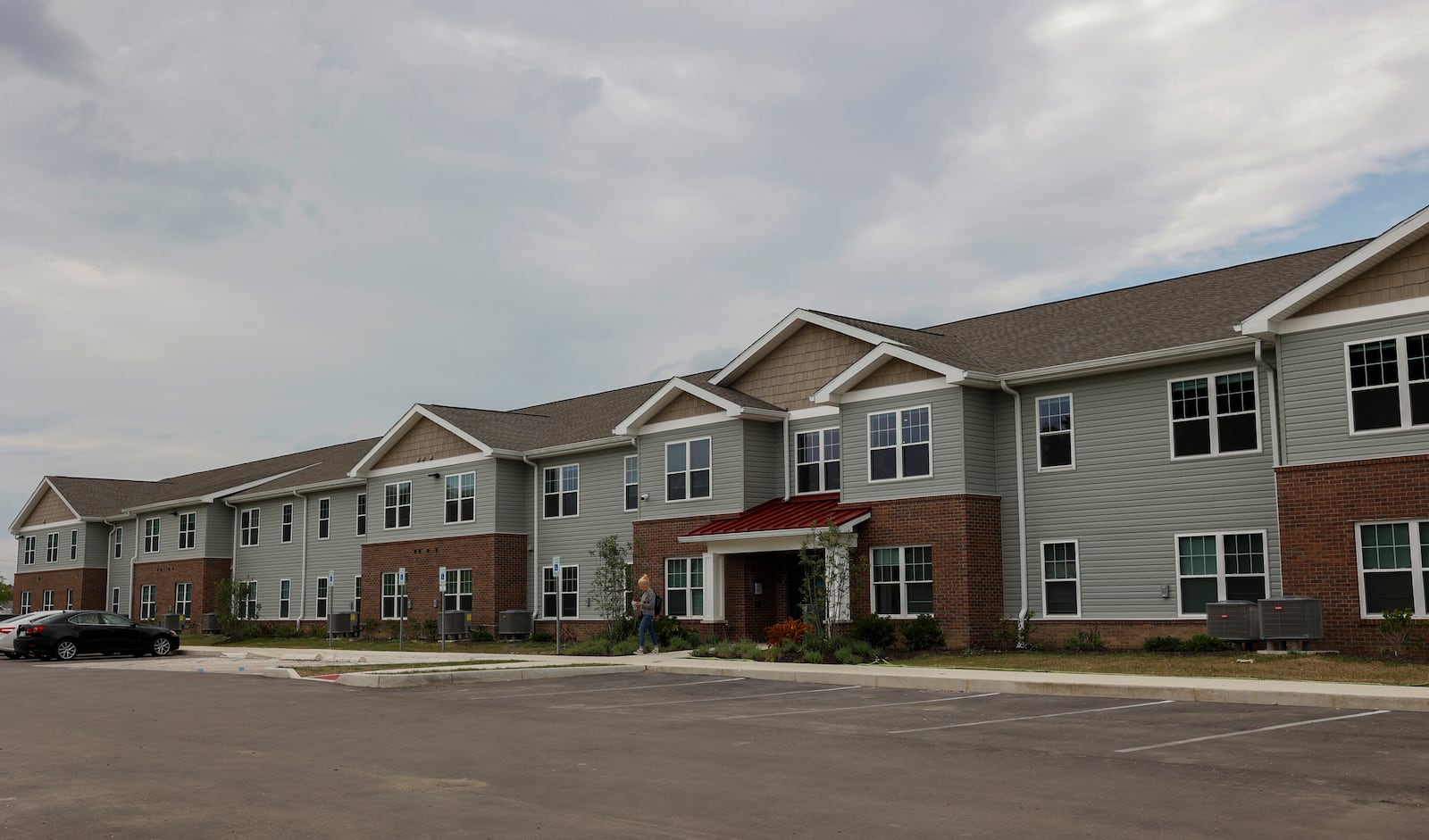 A woman walks out of the Rose Commons Apartments on Tuesday, August 5, 2025, in Springfield. JOSEPH COOKE/STAFF