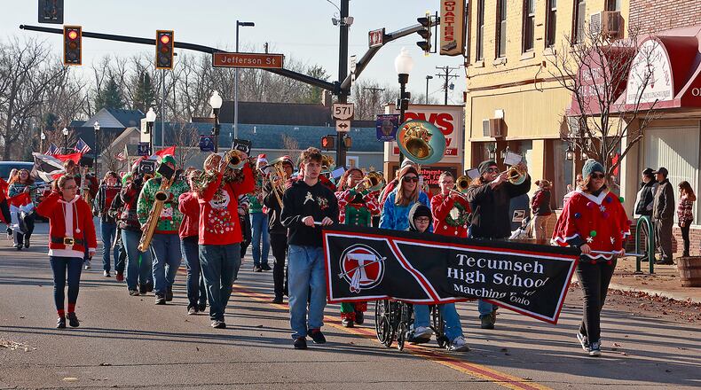 Strong winds prevented the inflatable holiday characters from being in the New Carlisle Christmas Parade but the holiday spirit was still felt throughout the city Saturday, Dec. 3, 2022. The Tecumseh Band marched in the parade with several characters, who passed out candy along the parade route. Santa was on hand and visited with children and posed for pictures at the New Carlisle Fire Station. BILL LACKEY/STAFF