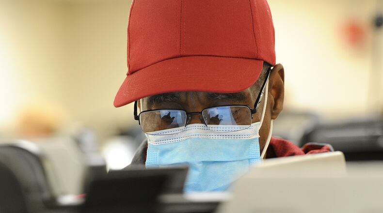Jimmy Howard, waited in long lines Tuesday morning to vote early at the Montgomery County Board of Elections. MARSHALL GORBY\STAFF