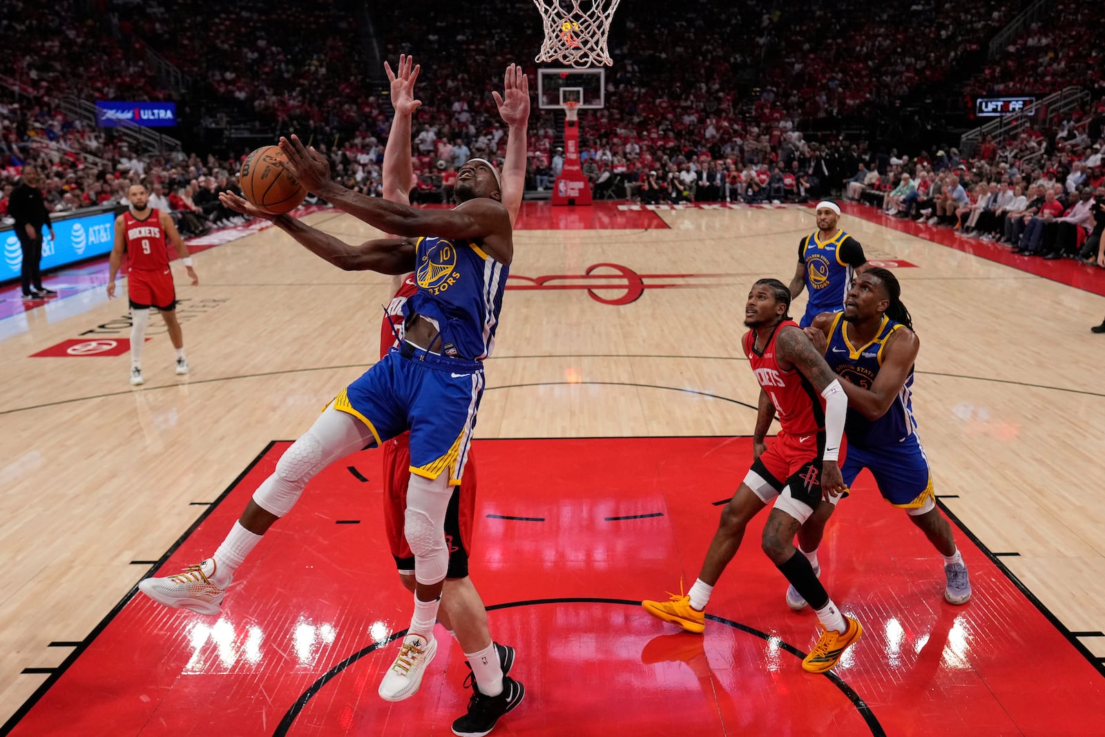 Golden State Warriors forward Jimmy Butler III (10) shoots around Houston Rockets center Alperen Sengun during the first half of Game 5 of an NBA basketball first-round playoff series, Wednesday, April 30, 2024, in Houston. (AP Photo/David J. Phillip)