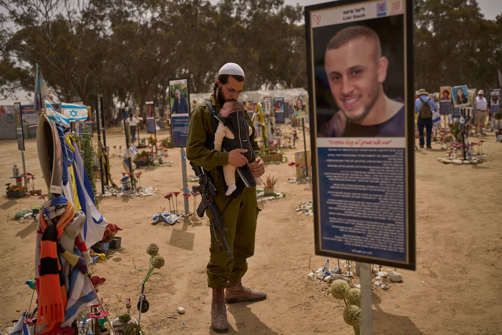 FILE - An Israeli soldier walks at the site of Oct. 7, 2023, attack by Hamas militants at the Nova music festival near Kibbutz Reim, southern Israel, April 30, 2025. (AP Photo/Ohad Zwigenberg, File)