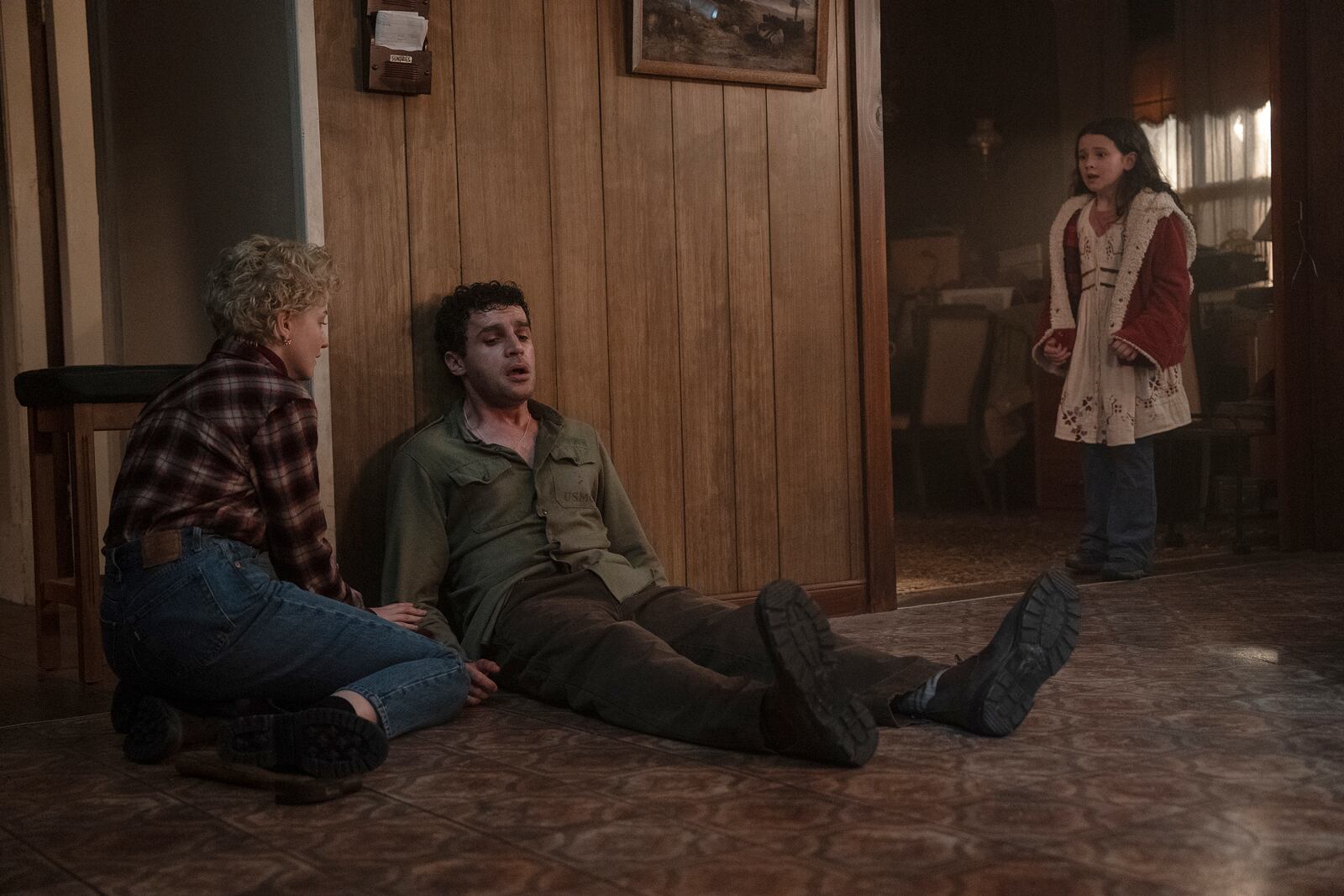 This image released by Universal Pictures shows Julia Garner, from left, Christopher Abbott, and Matilda Firth in a scene from "Wolf Man." (Nicola Dove/Universal Pictures via AP)
