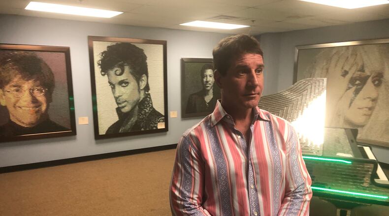 Masque owner Luke Liakos showed off his artwork as part of Downtown Dayton Partnership's First Friday in August. The artwork was displayed above the club opened at 34 N. Jefferson in 2004. Liakos announced in December that he will close the club Jan. 25 and is looking for a new location.